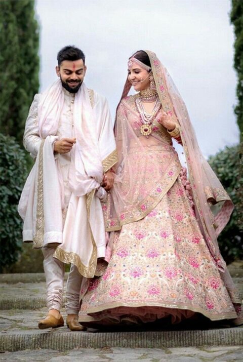 light pink color wedding outfit of Anuska and kohli