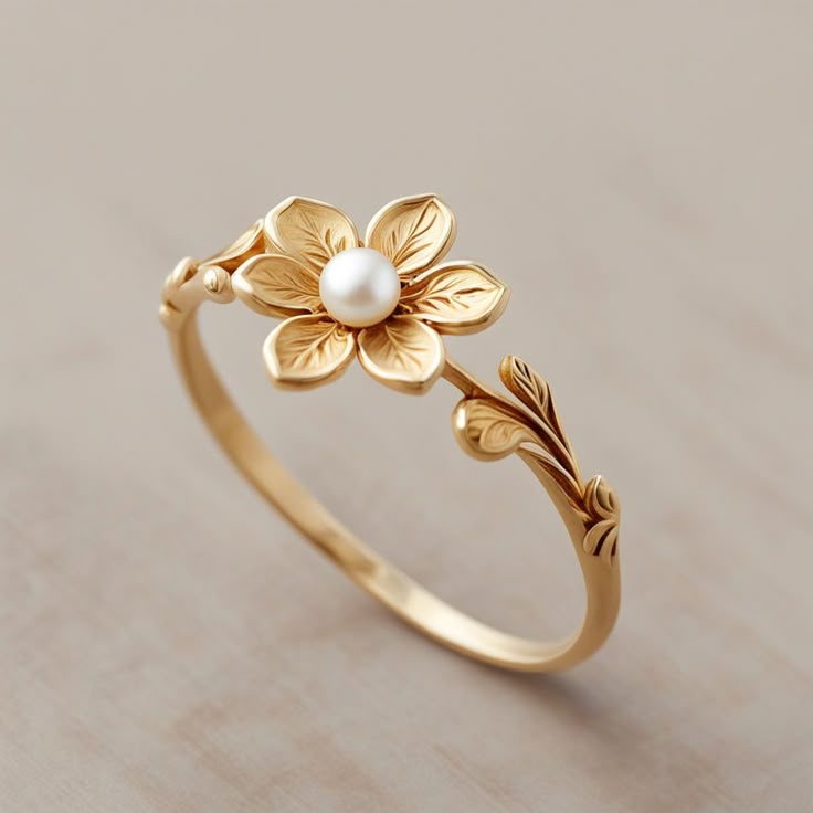 a-dainty-french-inspired-gold-ring-with-a-delicate-floral-design-and-a-small-pearl-accent