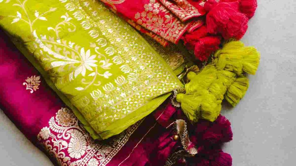 Banarasi silk (centre) and embroidered dupatta fabrics: each has a different weight, drape, and occasion